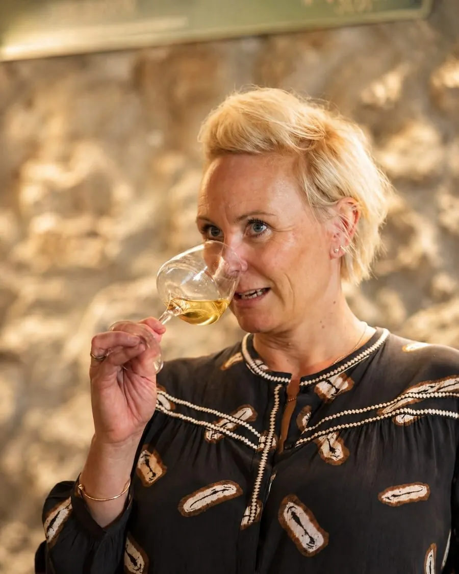 Anna Ölin, founder of VinoVoyages, in a Savoie vineyard at golden hour